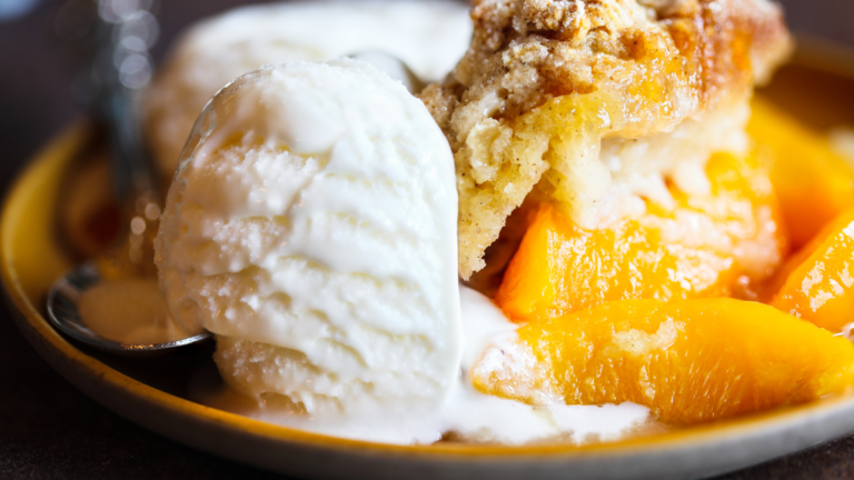 Canned vs Frozen Peaches for Cobbler: A side-by-side comparison of canned peaches in a tin and frozen peaches in a resealable bag on a rustic kitchen table with a peach cobbler in the background.