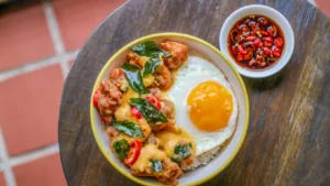 A hearty chicken and egg breakfast skillet with vegetables in a cast iron pan.