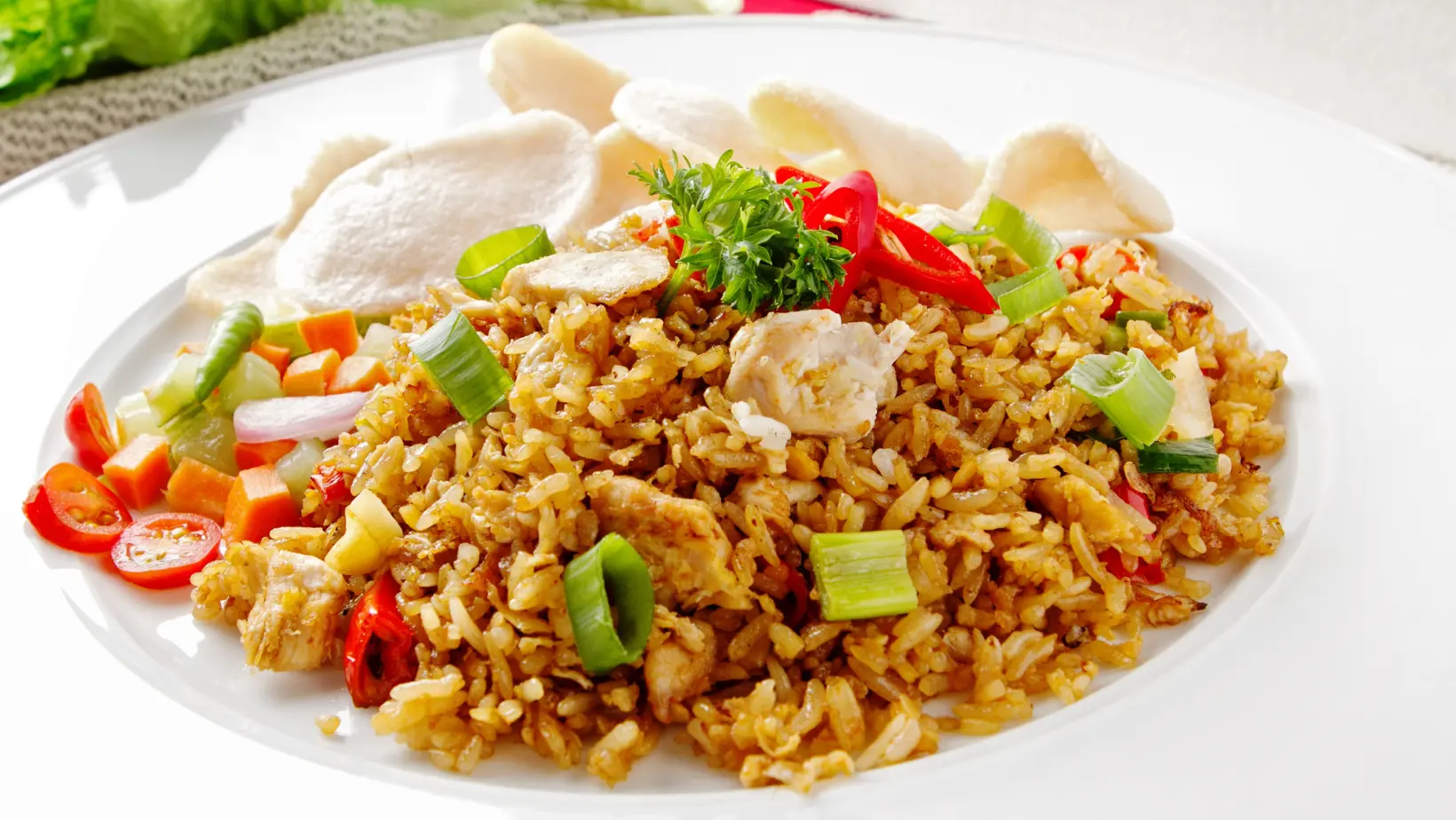 A bowl of gluten-free fried rice with fresh vegetables, egg, and tamari soy sauce.