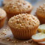 Freshly baked Apple & Egg Breakfast Muffins with oats and cinnamon on a rustic wooden table.